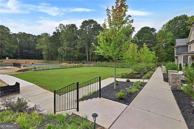 exterior space featuring a lawn and fence