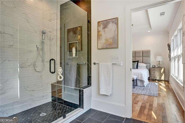 full bath featuring a shower stall, visible vents, wood finished floors, and ensuite bath