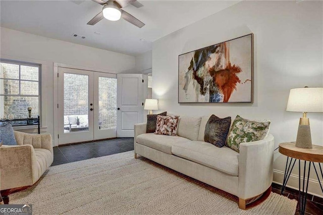 tiled living room featuring baseboards, visible vents, french doors, and a ceiling fan