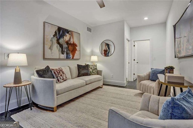 living area featuring baseboards, visible vents, and recessed lighting
