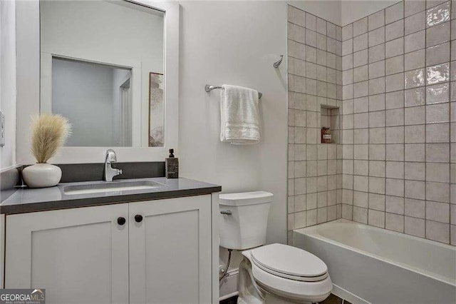 bathroom featuring shower / tub combination, toilet, and vanity