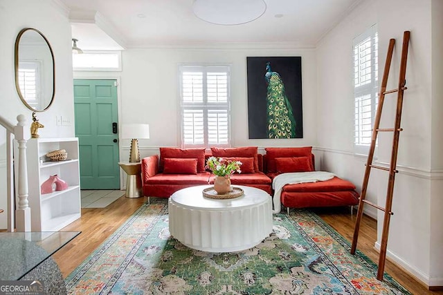 living room with baseboards, wood finished floors, and crown molding