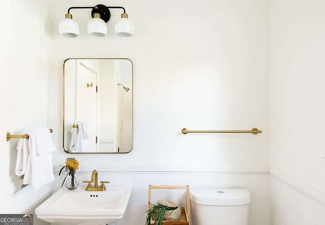 half bathroom with toilet and a sink