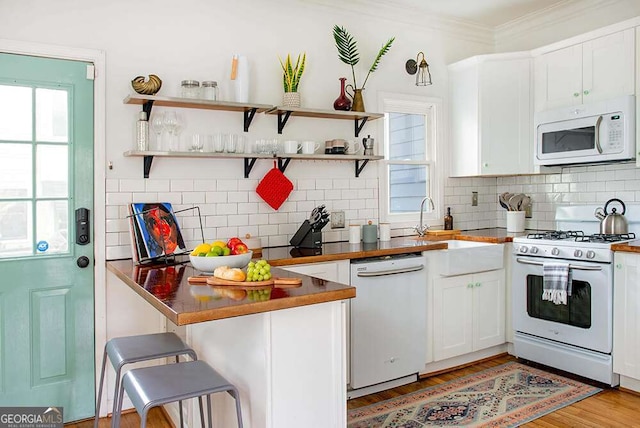 kitchen featuring open shelves, white appliances, white cabinets, and crown molding
