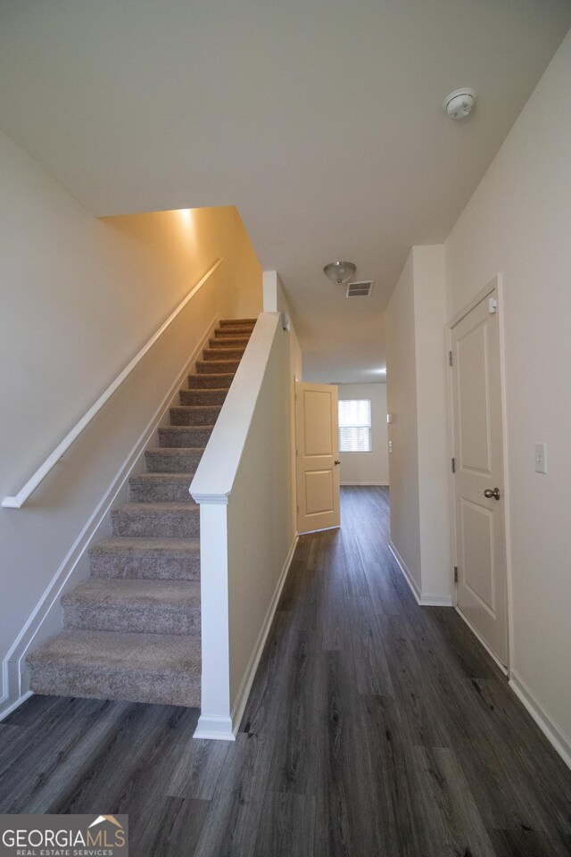 6342 Kinsland Ct, Lithonia, GA 30058 - staircase featuring baseboards, wood finished floors, and visible vents