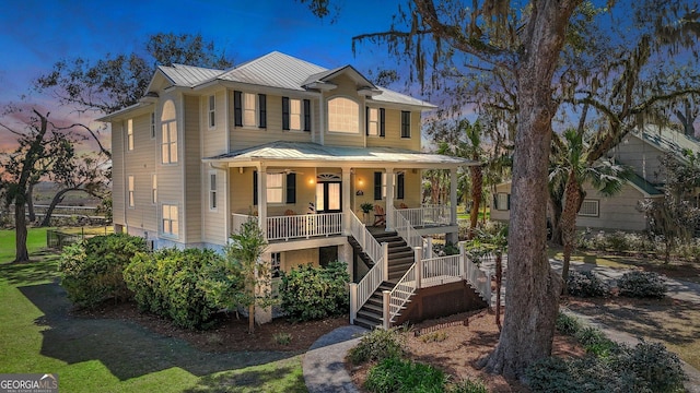 1108 E Mission Ln SE, Darien, GA 31305 - view of front facade featuring covered porch, stairs, a standing seam roof, and metal roof