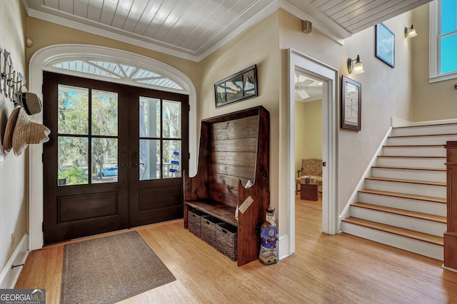 1108 E Mission Ln SE, Darien, GA 31305 - entryway with french doors, stairway, light wood finished floors, wood ceiling, and crown molding