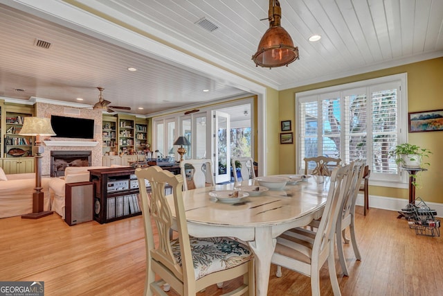1108 E Mission Ln SE, Darien, GA 31305 - dining area with a ceiling fan, ornamental molding, light wood-type flooring, a fireplace, and recessed lighting