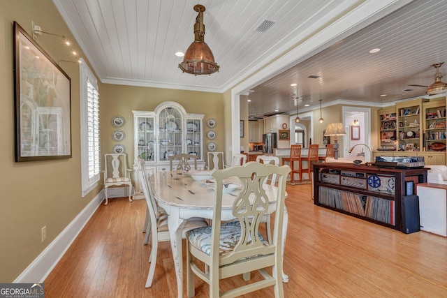 1108 E Mission Ln SE, Darien, GA 31305 - dining space featuring light wood-style floors, wood ceiling, ornamental molding, recessed lighting, and baseboards