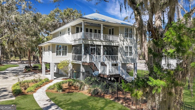 1108 E Mission Ln SE, Darien, GA 31305 - rear view of house with a balcony, ceiling fan, metal roof, and stairway
