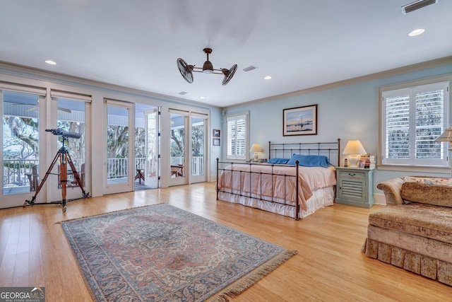 bedroom featuring ornamental molding, french doors, visible vents, multiple windows, and access to exterior