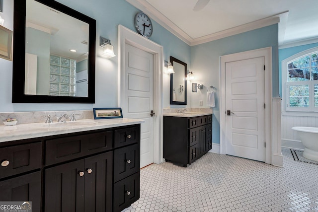 1108 E Mission Ln SE, Darien, GA 31305 - full bathroom featuring two vanities, ornamental molding, a freestanding tub, and wainscoting