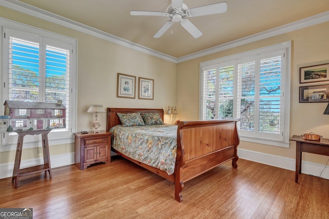 1108 E Mission Ln SE, Darien, GA 31305 - bedroom featuring light wood-style floors, multiple windows, ornamental molding, baseboards, and ceiling fan