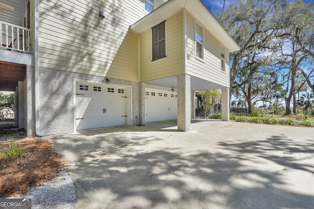 view of home's exterior featuring an attached garage and concrete driveway