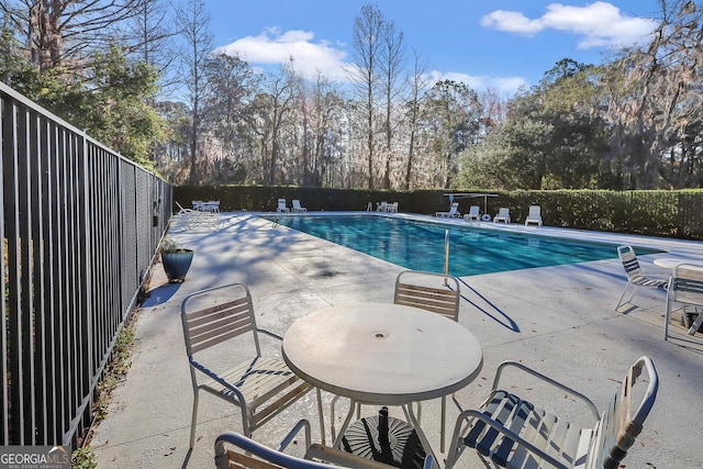 1108 E Mission Ln SE, Darien, GA 31305 - community pool featuring a patio and view of wooded area