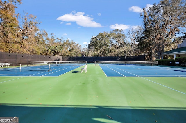 view of tennis court featuring fence