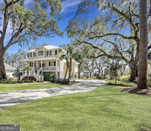 1108 E Mission Ln SE, Darien, GA 31305 - view of front of house with a porch, driveway, stairs, and a front yard