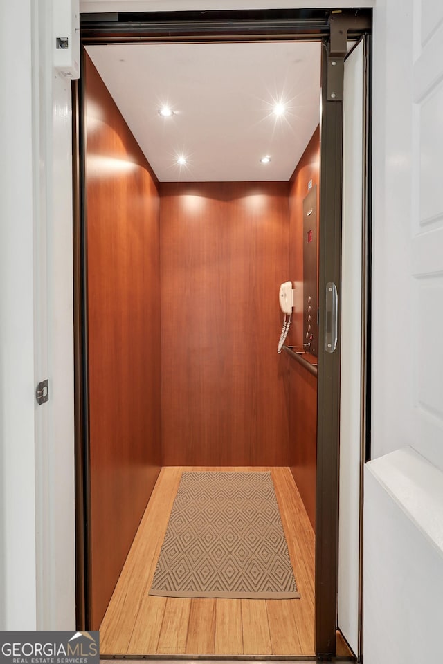 1108 E Mission Ln SE, Darien, GA 31305 - elevator with wood finished floors and recessed lighting