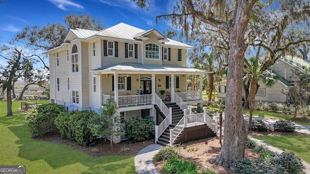 1108 E Mission Ln SE, Darien, GA 31305 - view of front of home with a porch, a standing seam roof, metal roof, stairs, and a front yard