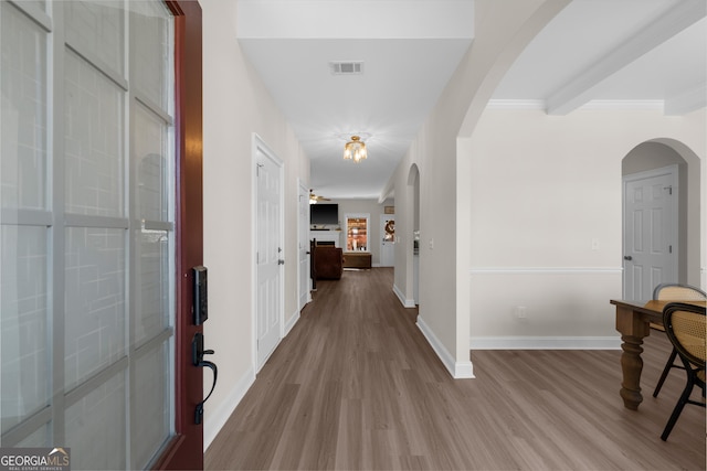 236 Village Park Dr, Newnan, GA 30265 - corridor featuring wood finished floors, baseboards, crown molding, and arched walkways
