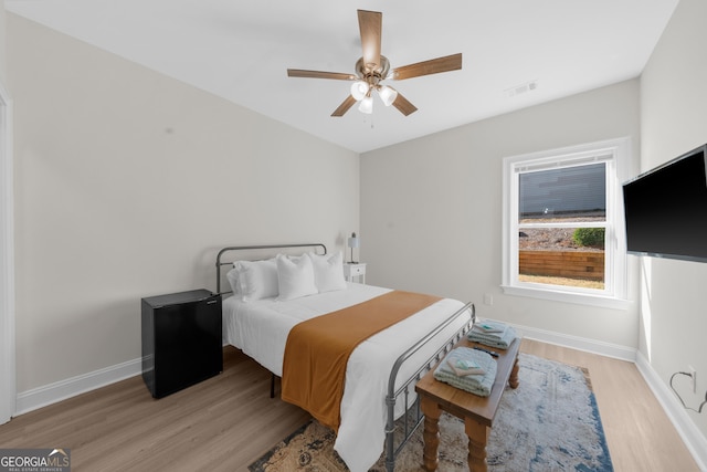 236 Village Park Dr, Newnan, GA 30265 - bedroom with light wood-type flooring, baseboards, and a ceiling fan