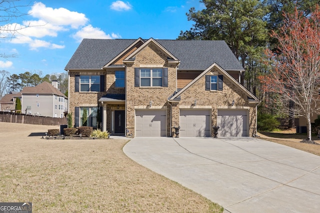 2441 Noelle Ln, Powder Springs, GA 30127 - view of front facade featuring concrete driveway, an attached garage, brick siding, and a front yard