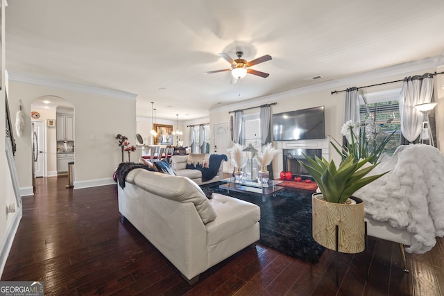 2441 Noelle Ln, Powder Springs, GA 30127 - living area with dark wood finished floors, ceiling fan with notable chandelier, and arched walkways