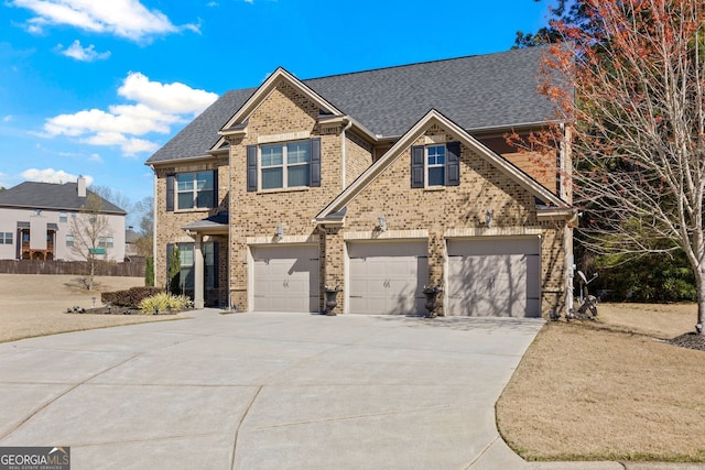 2441 Noelle Ln, Powder Springs, GA 30127 - view of front of house with an attached garage, brick siding, driveway, and a shingled roof