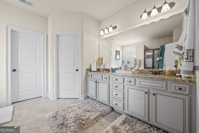 2441 Noelle Ln, Powder Springs, GA 30127 - full bath featuring tile patterned floors, visible vents, a sink, double vanity, and walk in shower