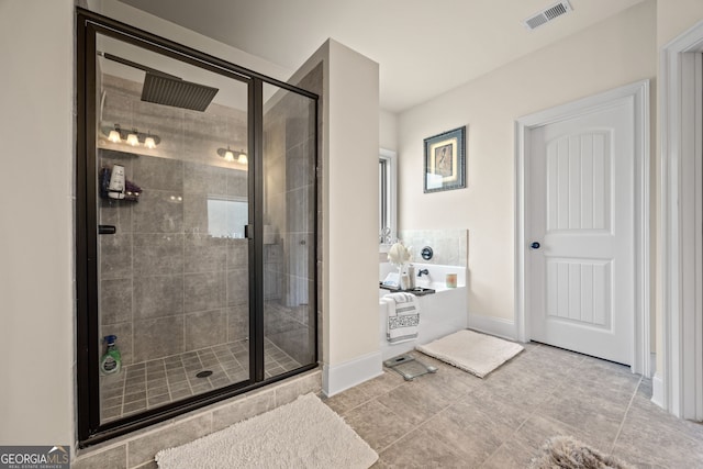 2441 Noelle Ln, Powder Springs, GA 30127 - bathroom with visible vents, baseboards, a stall shower, and a bath