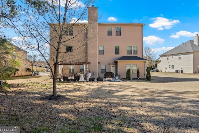 2441 Noelle Ln, Powder Springs, GA 30127 - back of house featuring a patio and a chimney