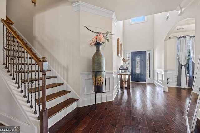 2441 Noelle Ln, Powder Springs, GA 30127 - entrance foyer with a wainscoted wall, hardwood / wood-style flooring, stairway, arched walkways, and a decorative wall