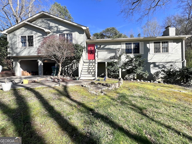 4436 Old Country Way, Snellville, GA 30039 - tri-level home with a chimney, a garage, stairway, a front yard, and brick siding