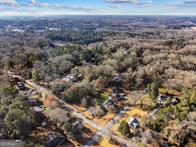 birds eye view of property featuring a forest view