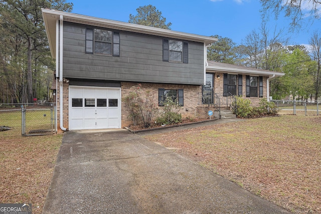 175 Slicky Rock Ct, Riverdale, GA 30274 - tri-level home featuring an attached garage, driveway, and brick siding