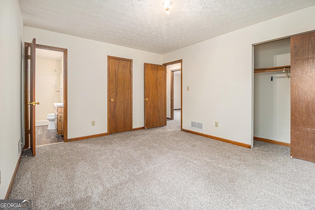 175 Slicky Rock Ct, Riverdale, GA 30274 - unfurnished bedroom featuring carpet flooring, a textured ceiling, and ensuite bathroom