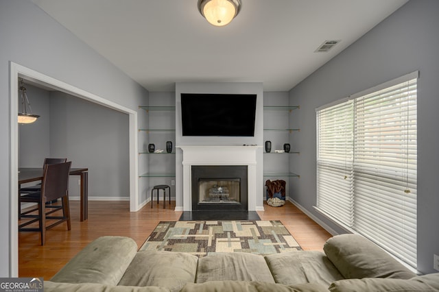 5381 Briar Creek Ln, Norcross, GA 30071 - living room featuring wood finished floors, a fireplace with flush hearth, baseboards, and built in features