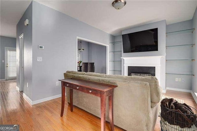 5381 Briar Creek Ln, Norcross, GA 30071 - living room featuring baseboards, a fireplace, wood finished floors, and built in shelves