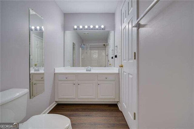 5381 Briar Creek Ln, Norcross, GA 30071 - bathroom with toilet, wood finished floors, vanity, and a shower