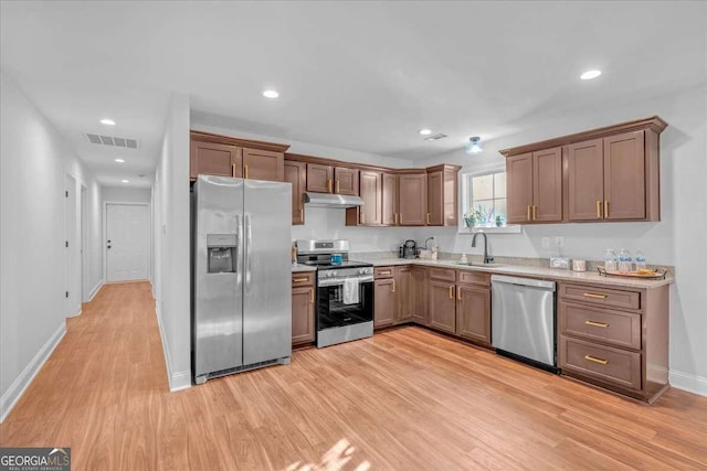 149 Irwin St, Cedartown, GA 30125 - kitchen with appliances with stainless steel finishes, light wood finished floors, a sink, light countertops, and baseboards