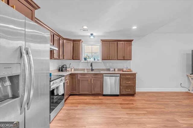 149 Irwin St, Cedartown, GA 30125 - kitchen with appliances with stainless steel finishes, under cabinet range hood, a sink, light wood-type flooring, and recessed lighting