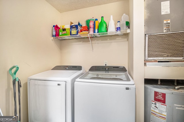 laundry room with water heater, separate washer and dryer, and laundry area