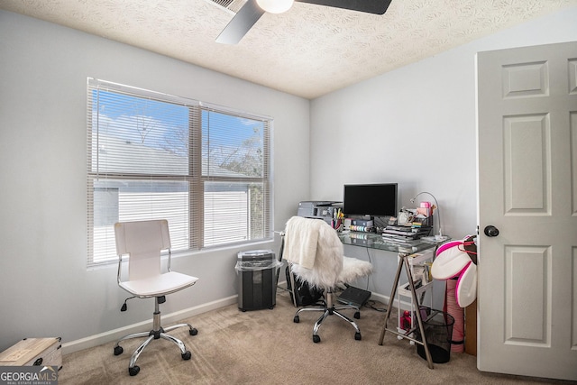 home office featuring baseboards, a textured ceiling, carpet flooring, and a ceiling fan