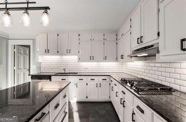 3672 Howell Wood Trl NW, Duluth, GA 30096 - kitchen with under cabinet range hood, decorative backsplash, white cabinets, and dark stone countertops