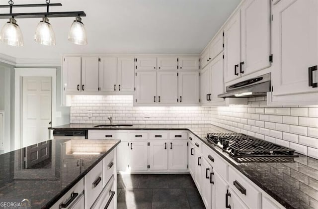 3672 Howell Wood Trl NW, Duluth, GA 30096 - kitchen with under cabinet range hood, a sink, dark stone countertops, backsplash, and white cabinetry
