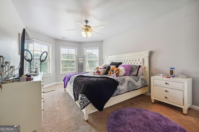 carpeted bedroom featuring baseboards, ceiling fan, and visible vents