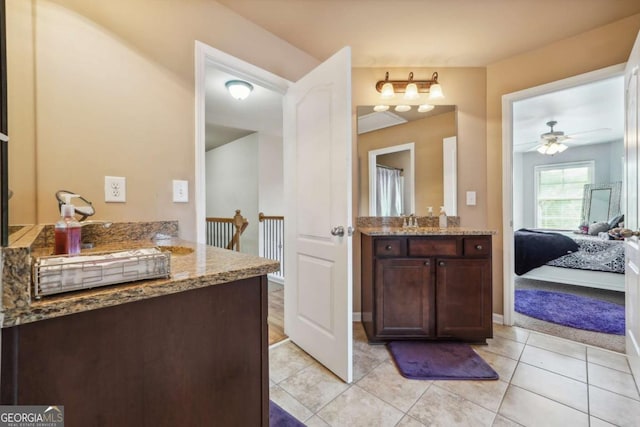 bathroom with a ceiling fan, ensuite bathroom, tile patterned flooring, and vanity