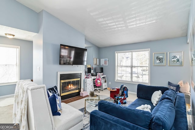 909 Glenleaf Dr, Peachtree Corners, GA 30092 - carpeted living area featuring a glass covered fireplace, baseboards, healthy amount of natural light, and lofted ceiling