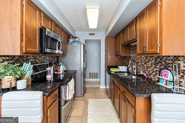 909 Glenleaf Dr, Peachtree Corners, GA 30092 - kitchen with appliances with stainless steel finishes, a sink, and brown cabinets