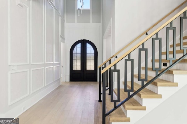3057 Bold Springs Rd, Dacula, GA 30019 - foyer featuring stairs, a decorative wall, french doors, and a towering ceiling
